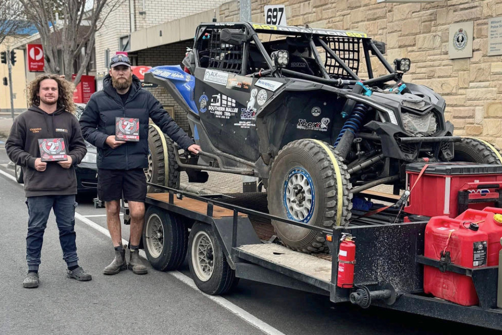 Baillie Farley and Cameron Grayson holding their second-place shields in the Class 6 ARB Australian Off Road Championship next to the 697 buggy.
