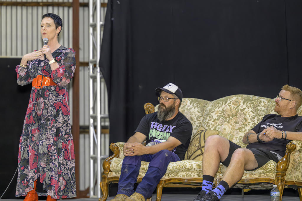 Special guest speaker Rae Bonney OAM speaks to the crowd as Simon Clark and Justin Knorpp listening intently.