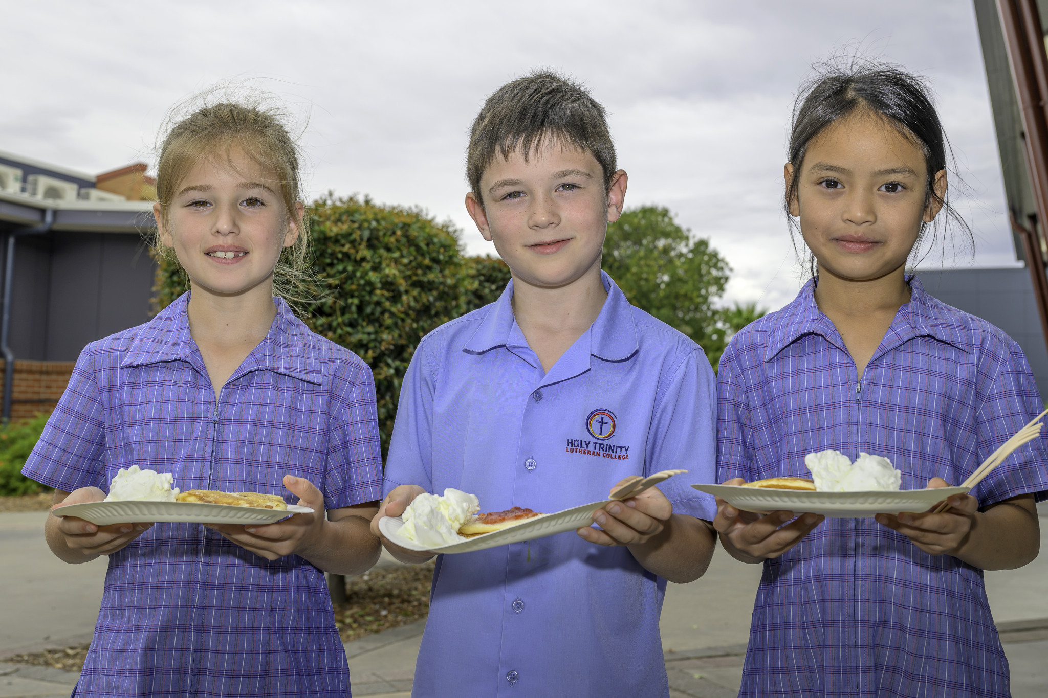 Hadley Webb, Baxter Argall and Htee Paw Say were all smiles before digging in to their pancakes.
