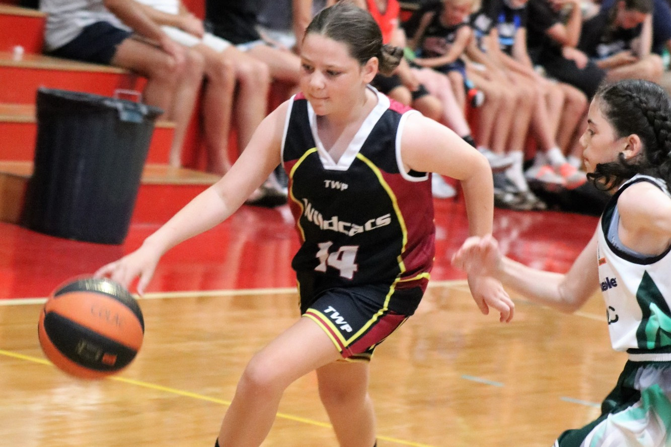 DRIBBLE: Wildcat Ayla Gunn dribbles the ball past Colac White players in front of a Horsham crowd. Photo: CAZ KOSCHITZKE.