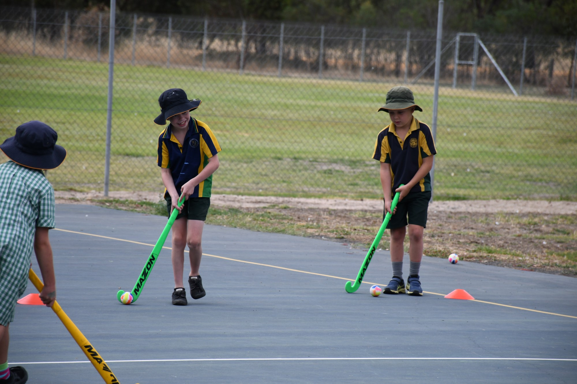 LEARNING A SPORT: Haven Primary School students Lucas Purchase and Duncan Newberry are practising different hockey movements at the hockey roadshow. Photo: ABBY WALTER.