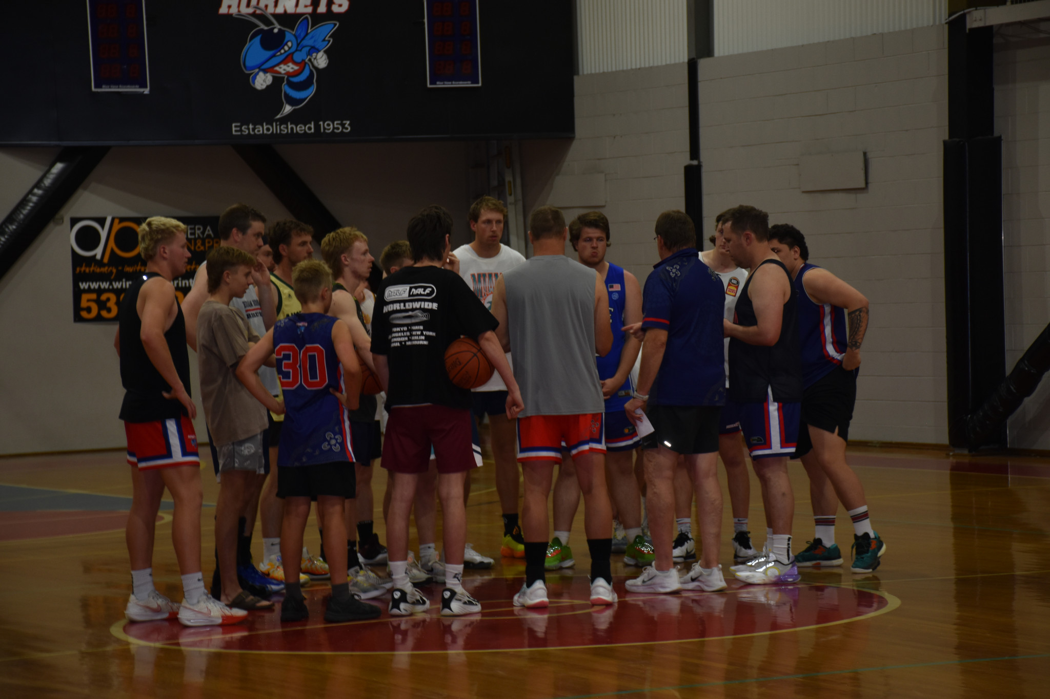 Coach Scott Benbow addresses the players before the training session.