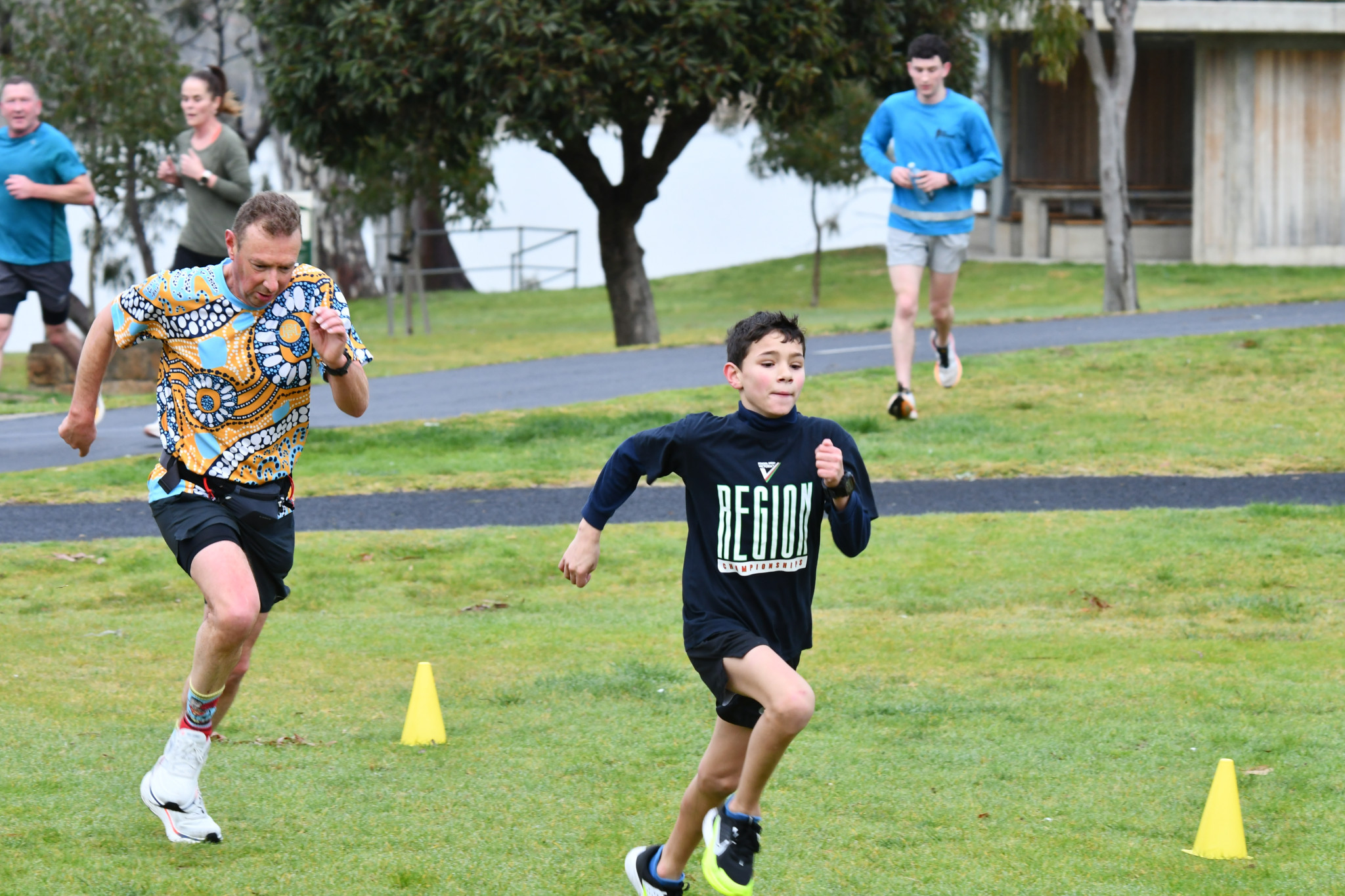 Mark Busbridge (left) and Mason Kennedy (right) approach the finish of Saturday’s parkrun.