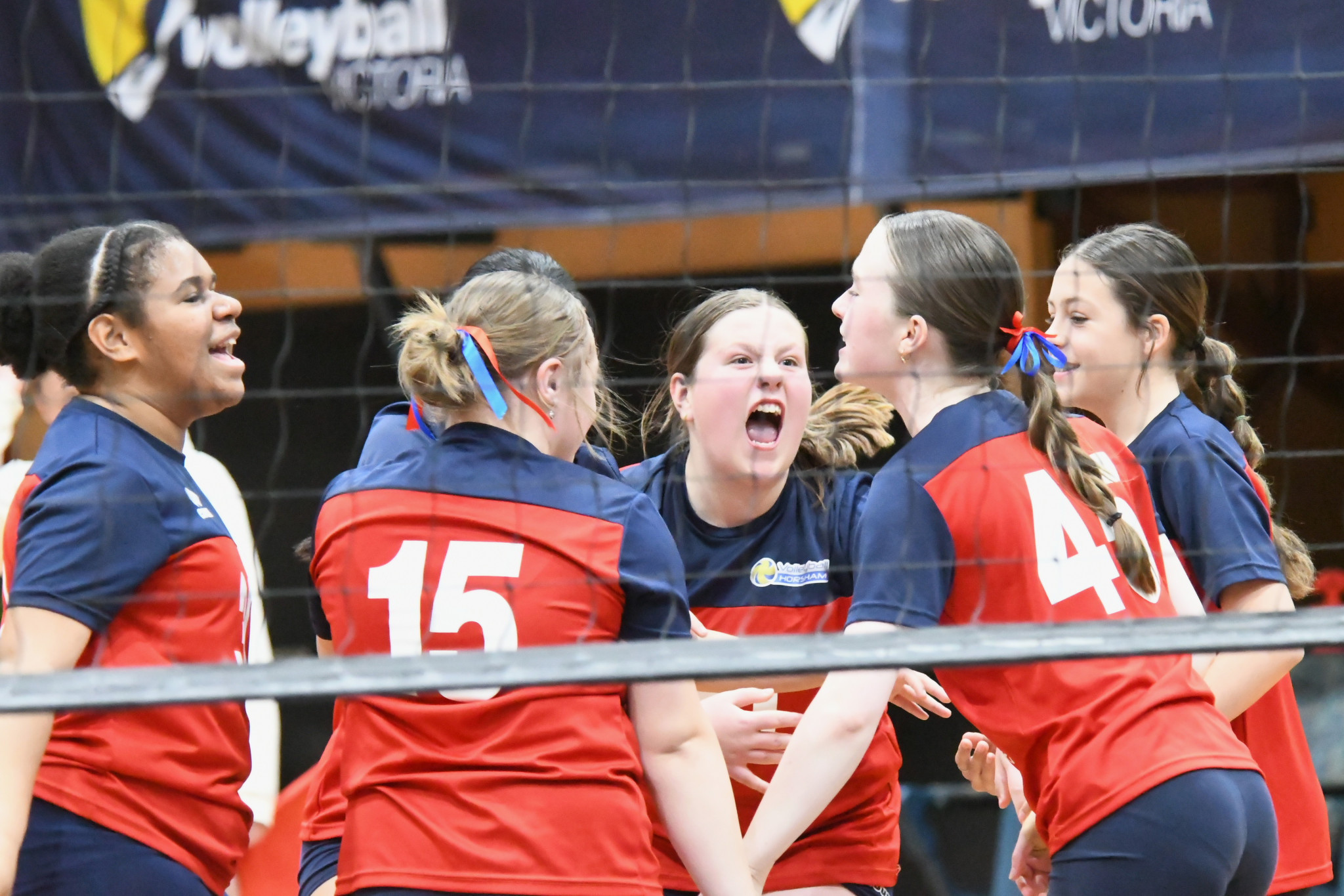 Horsham’s under 15s girls side celebrates a point during their final day clash against Macedon Ranges.