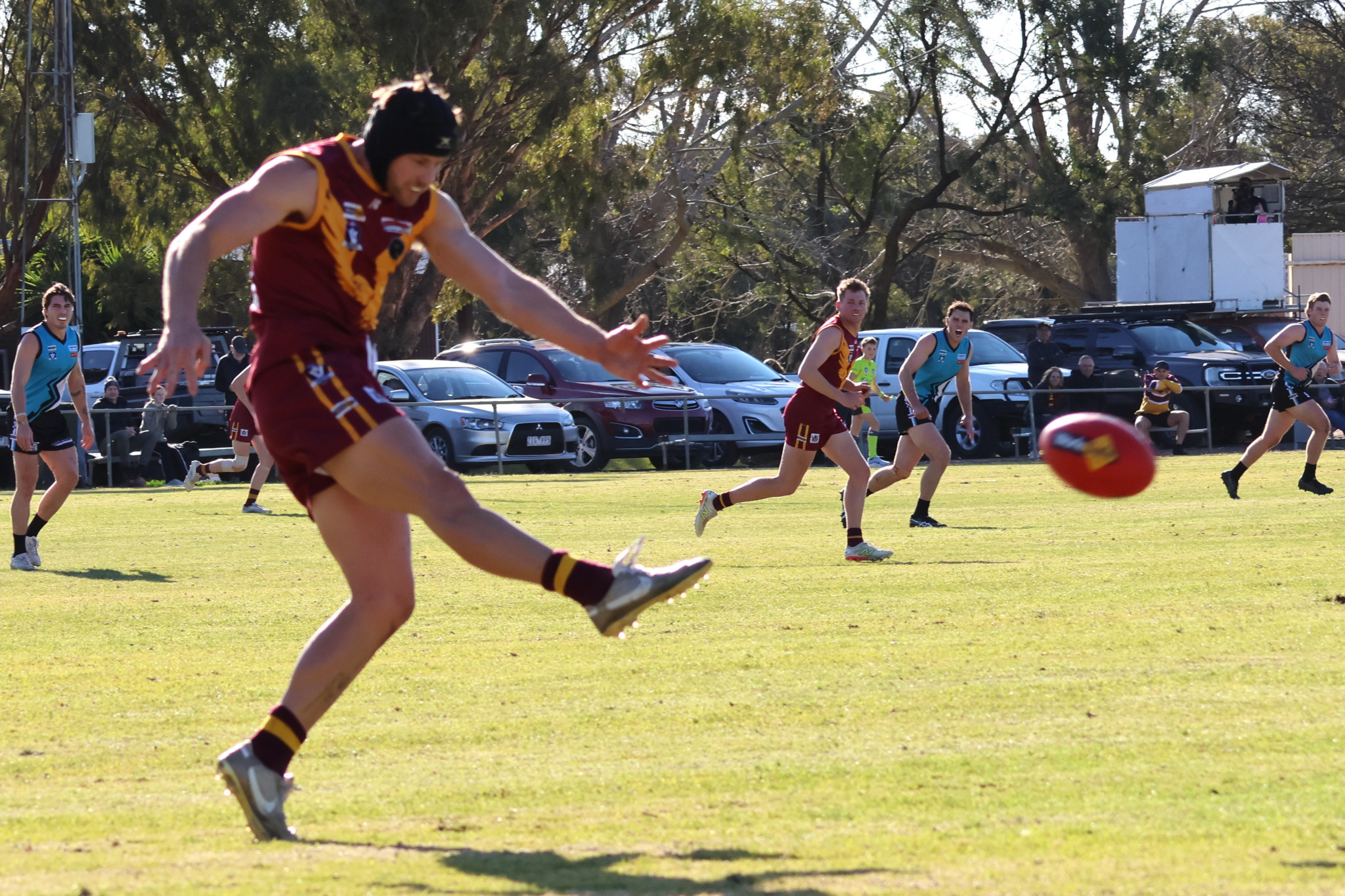 Sam Hanna boots the footy to the advantage of his side.