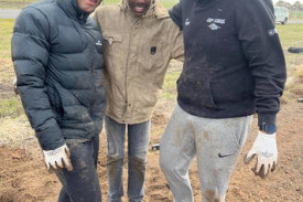 Youth mayor Tom Luke, 17, Sanjo Ruban, 13, and Shivansh Bhutani, 16, battle with muddy conditions. Photos: EMILY FRIEDRICHSEN