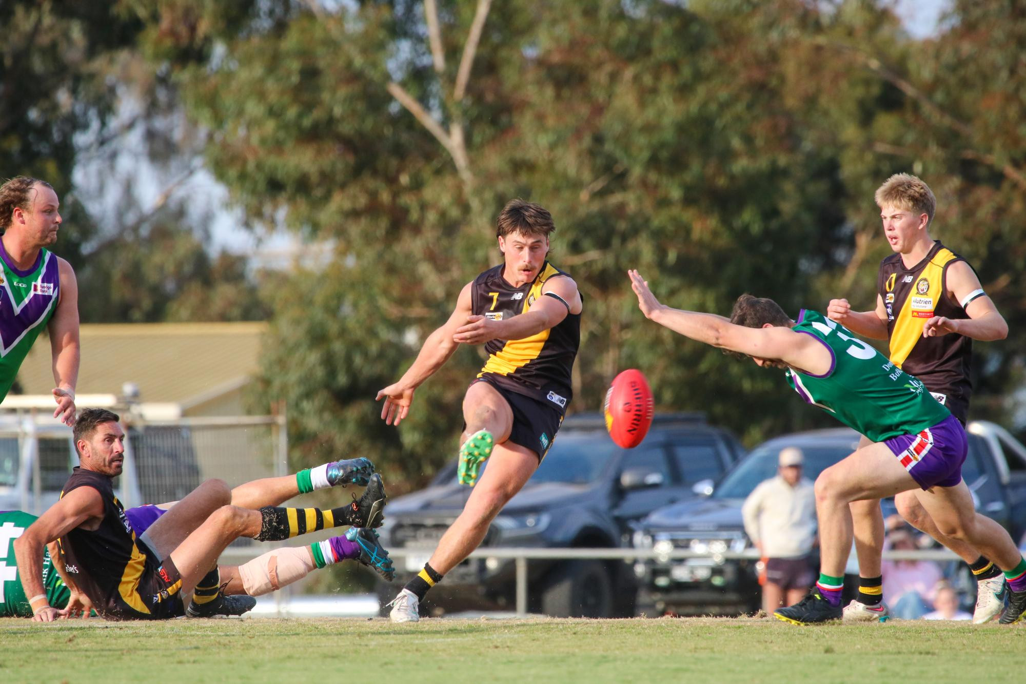 Wade Donnan clears the ball from the centre as Meyrick Buchanan attempts to smother. Picture by Blake Lee