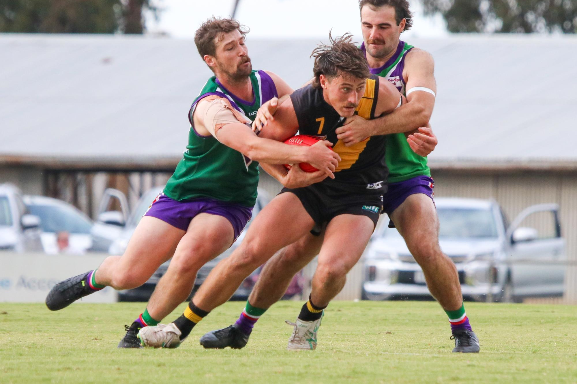 Wade Donnan is taken down by Meyrick Buchanan and Ben Hogan. Picture by Blake Lee