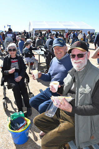 Warracknabeal’s Margaret and Neville Keam, with Walter Sholl stop for a bite to eat and a cuppa while watching the opening of the 2022 Mallee Machinery Field Days. Photo: DAVID WARD