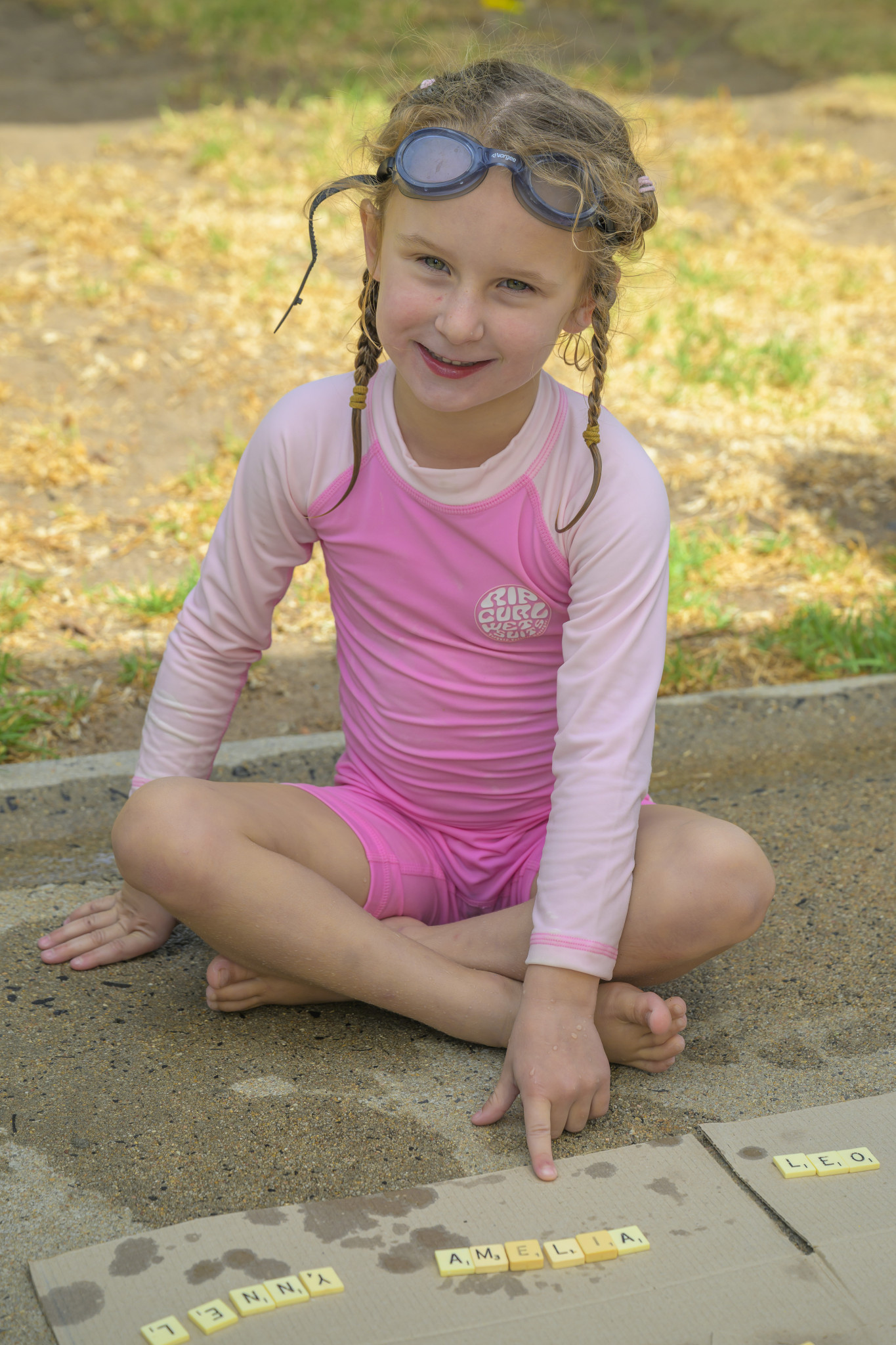 Amelia Emmett spells out her name using scrabble letters. Photo: ROBIN WEBB