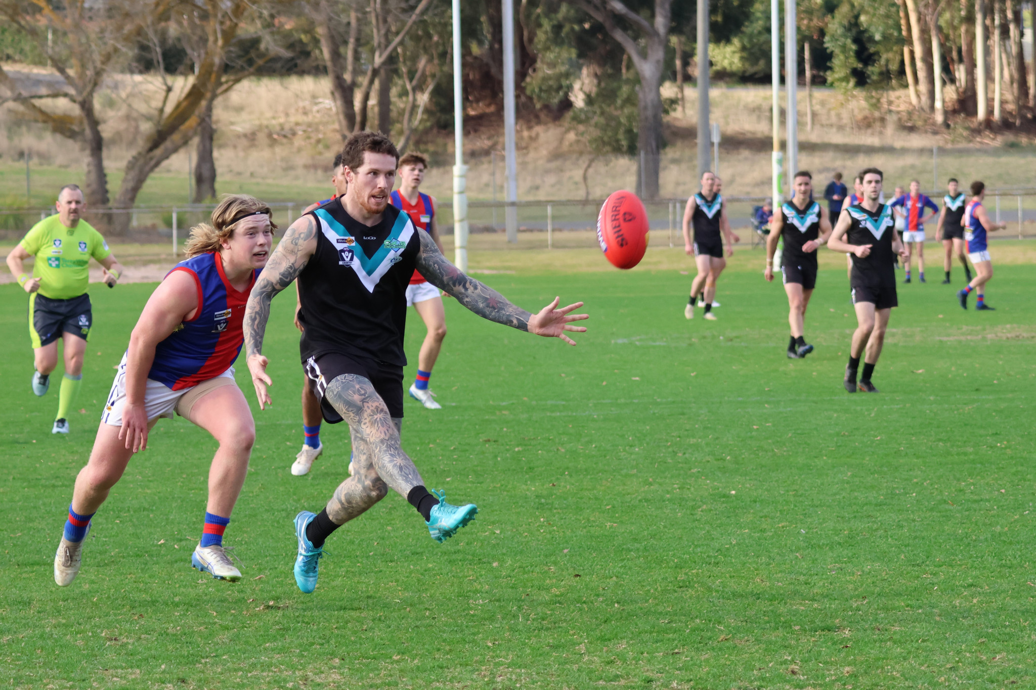 Ryan Folkes kicks upfield. Photo by TRISH RALPH