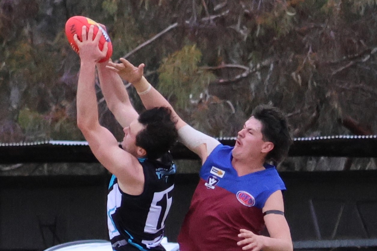 Southern Mallee Thunder's Reid Polack flies for a mark over Samuel Janetz.