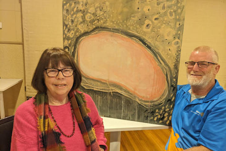 Brim artist Joan Goad shows her work titled 'Pink Lake in Summertime' which won best in show at the 2023 Horsham Rotary Art Fair. With her is Rotarian Tom Gallagher. Photo: FAYE SMITH