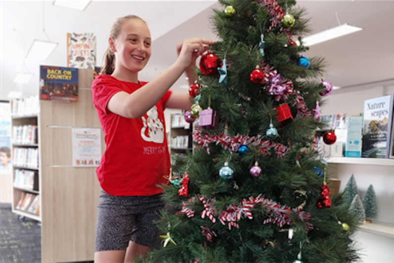 Chelsea Elliott decorates last year's Christmas Giving Tree.