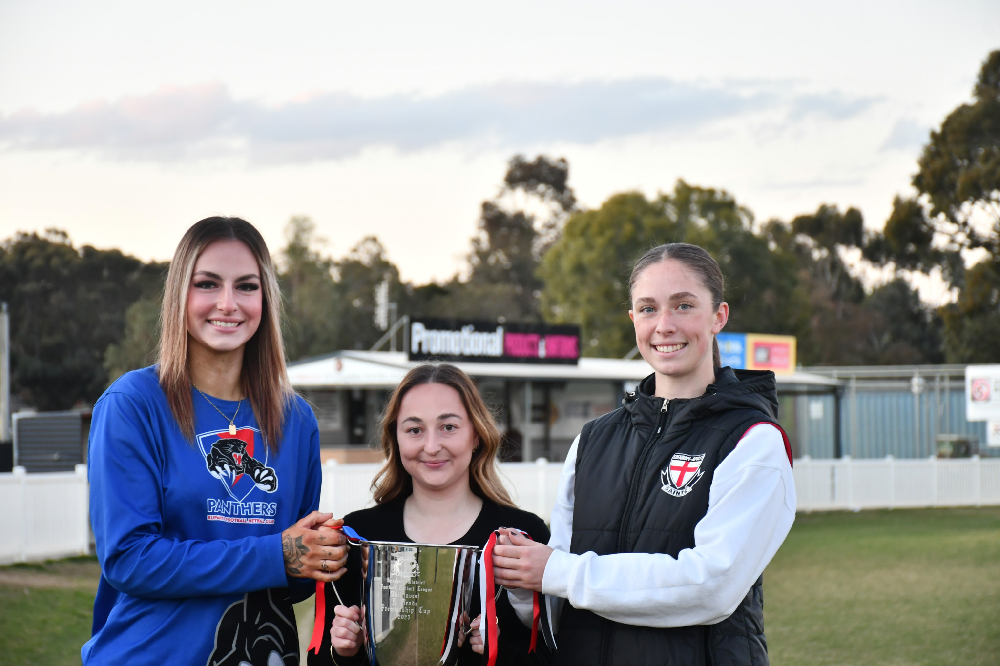 Rupanyup's Zanaiya Bergen (left), Skillsinvest's Brianna Luciani and Edenhope Apsley's Lavinia Fox hold the Skillsinvest A grade netball premiership cup.