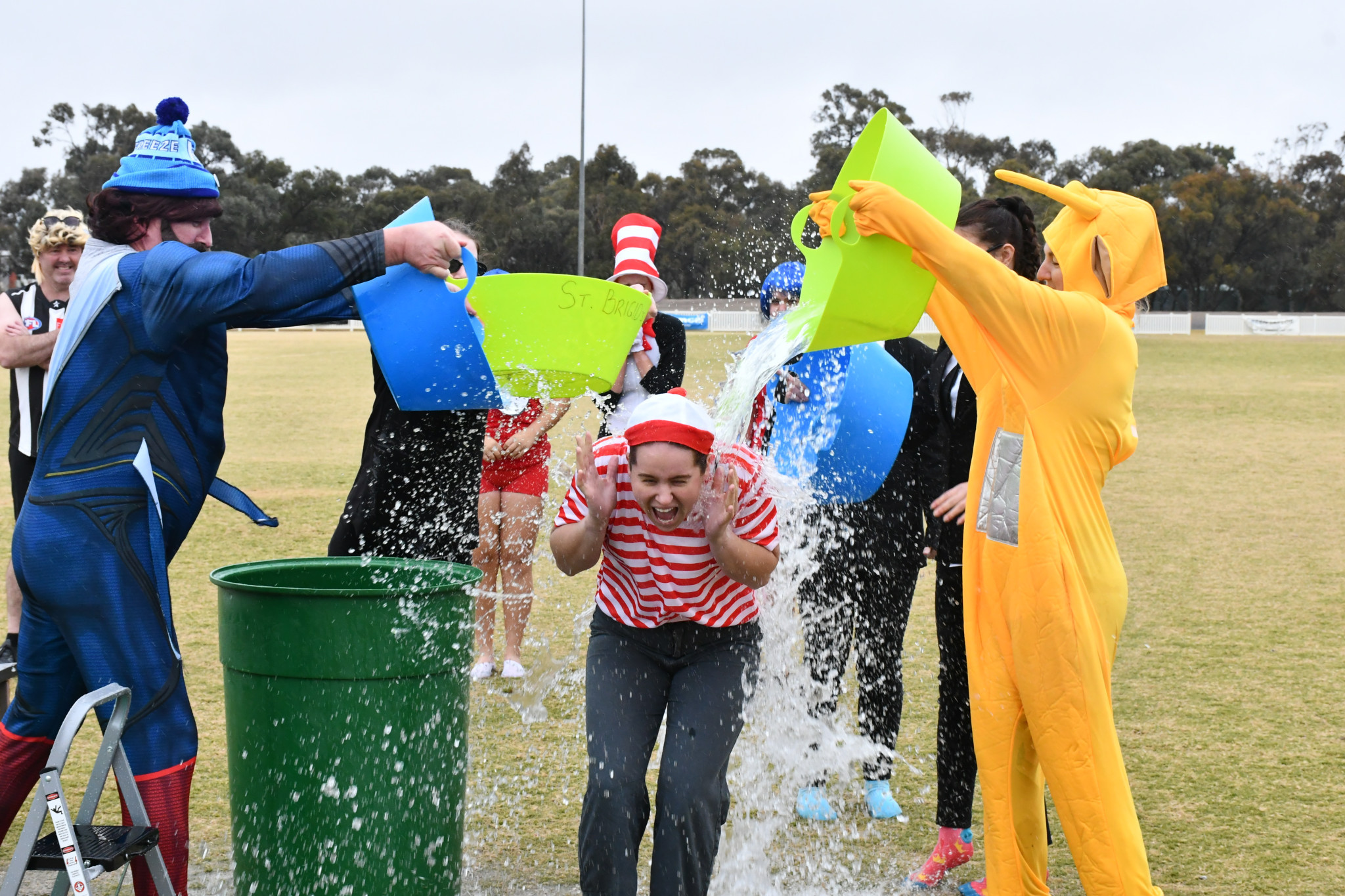 School staff members Gerard Raven and Ashlee Grace are pouring cold water on Holly Ruwoldt (centre) during the Big Freeze challenge last Friday. Photo: TAYYAAB MASROOR