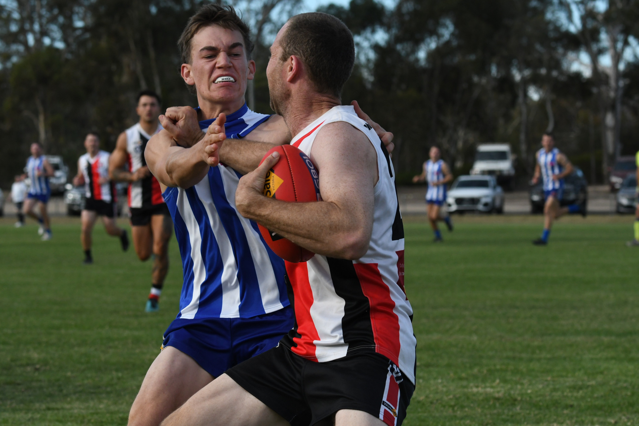 Edenhope Aplsey's Jeremy Kealy tries to break a tackle from Harrow Balmoral's Mitch Grant. PHOTO: CHRIS GRAETZ