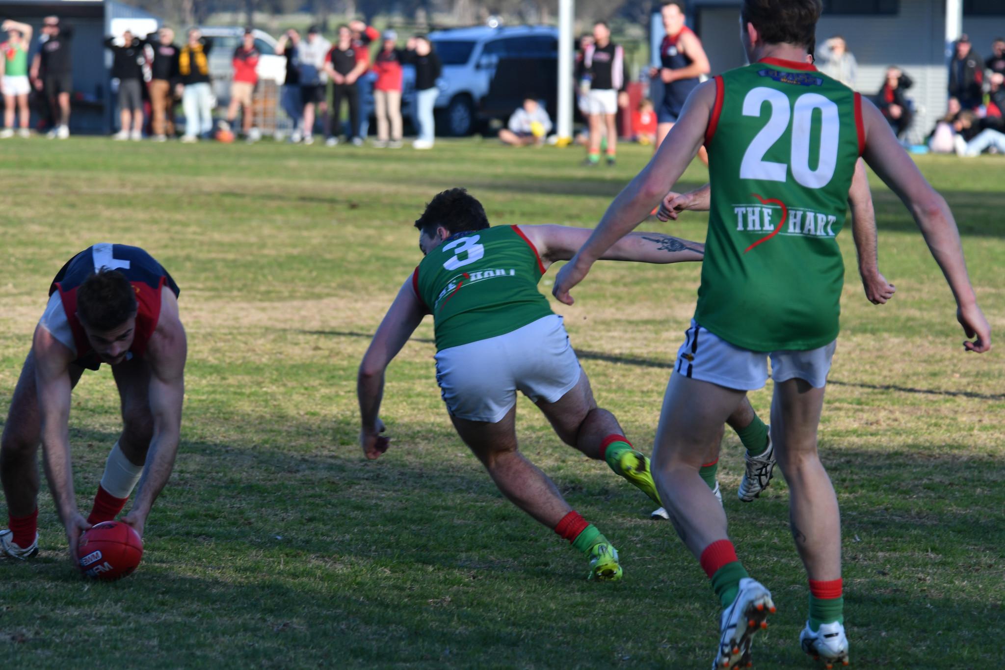 Laharum's Pat Lattanzio picks up the loose ball, surrounded by Noradjuha Quantong defenders.