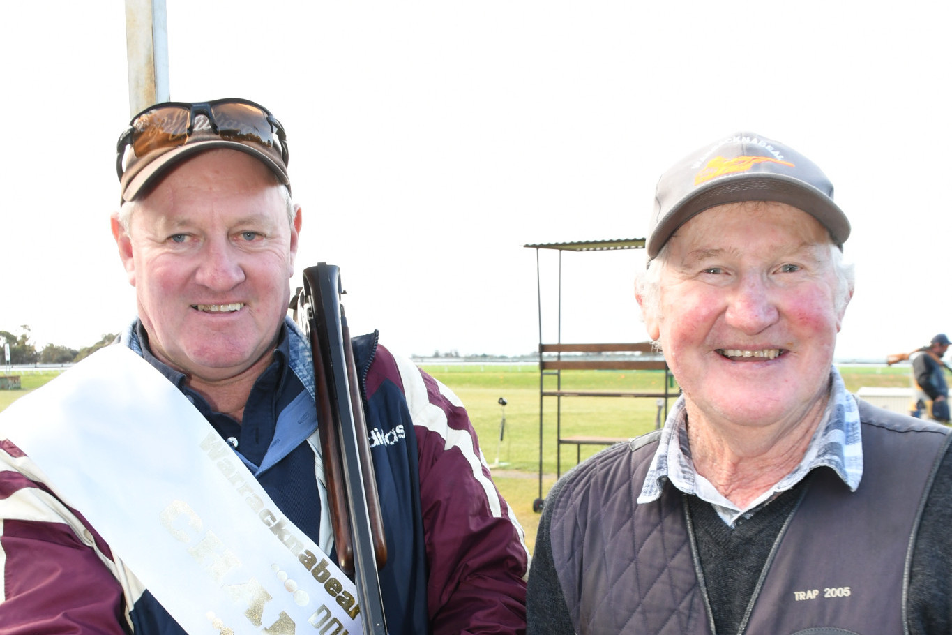 Overall Double Barrel Championship winner Wayne Hawkins from Kaniva is presented with his sash by Club president Roger Lehmann.