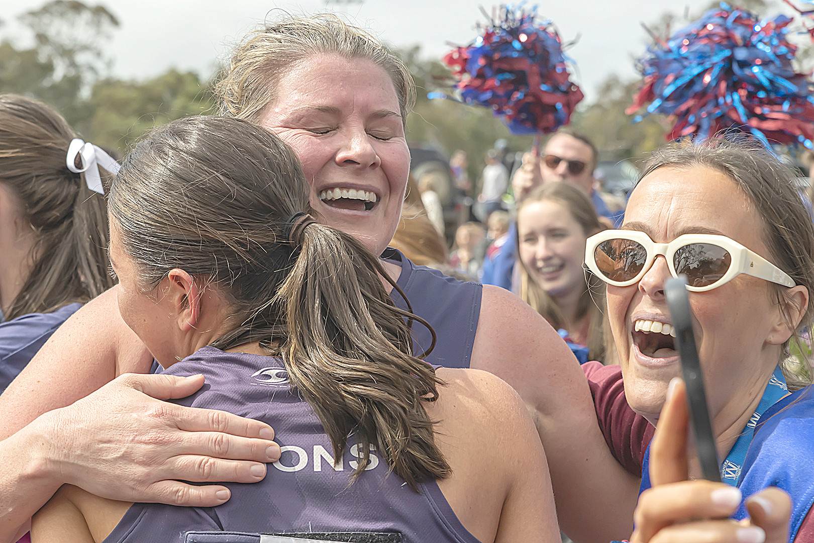 Ebonie Salter hugs a teammate after the win. PHOTO: SHANE ROBERTS