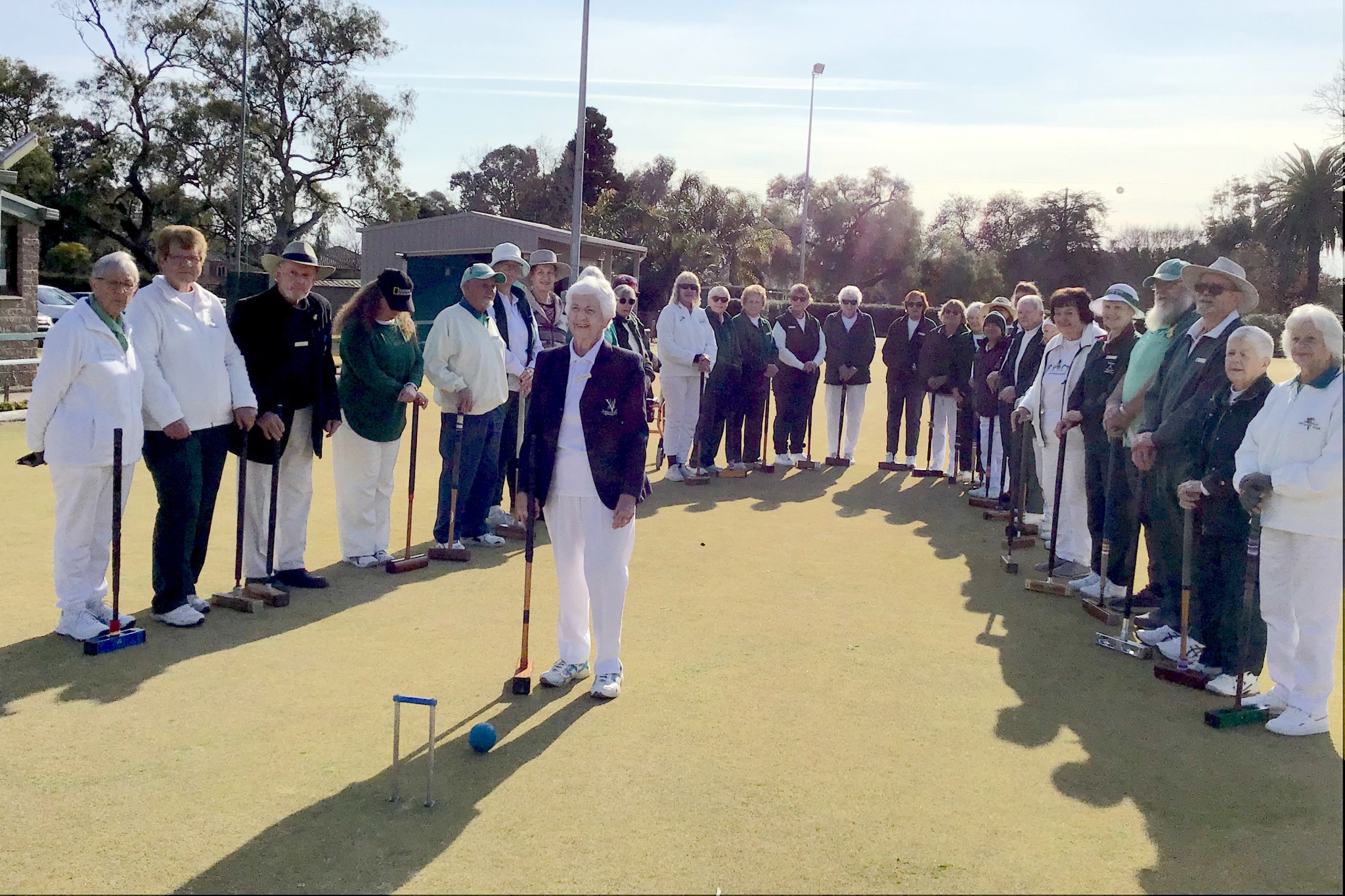 Fay Pearson rolled the first hoop to open the croquet season surrounded by 32 players