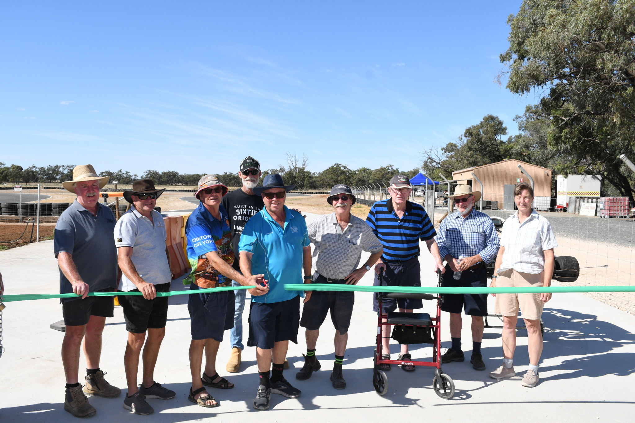 TRACK OPENING: Centre - Graham Muller and Doug Mitchell cut the ribbon at the track opening with from left-Peter King, Kelvin Sleep, Darren Gould, David Ward, Bob Kidman, Trevor Starbuck and Jennie Mitchell.