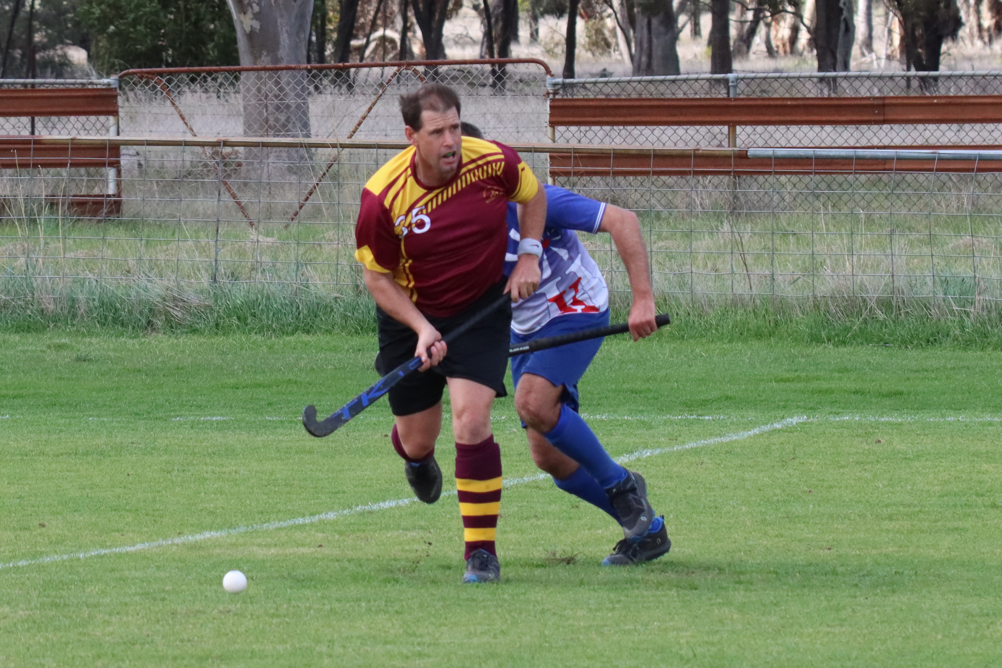 Warrack Hoops’ Mark Peters assesses his options for getting the ball into attack under pressure from Kaniva’s Adam Wallis (obscured). PHOTO: SIMON KING