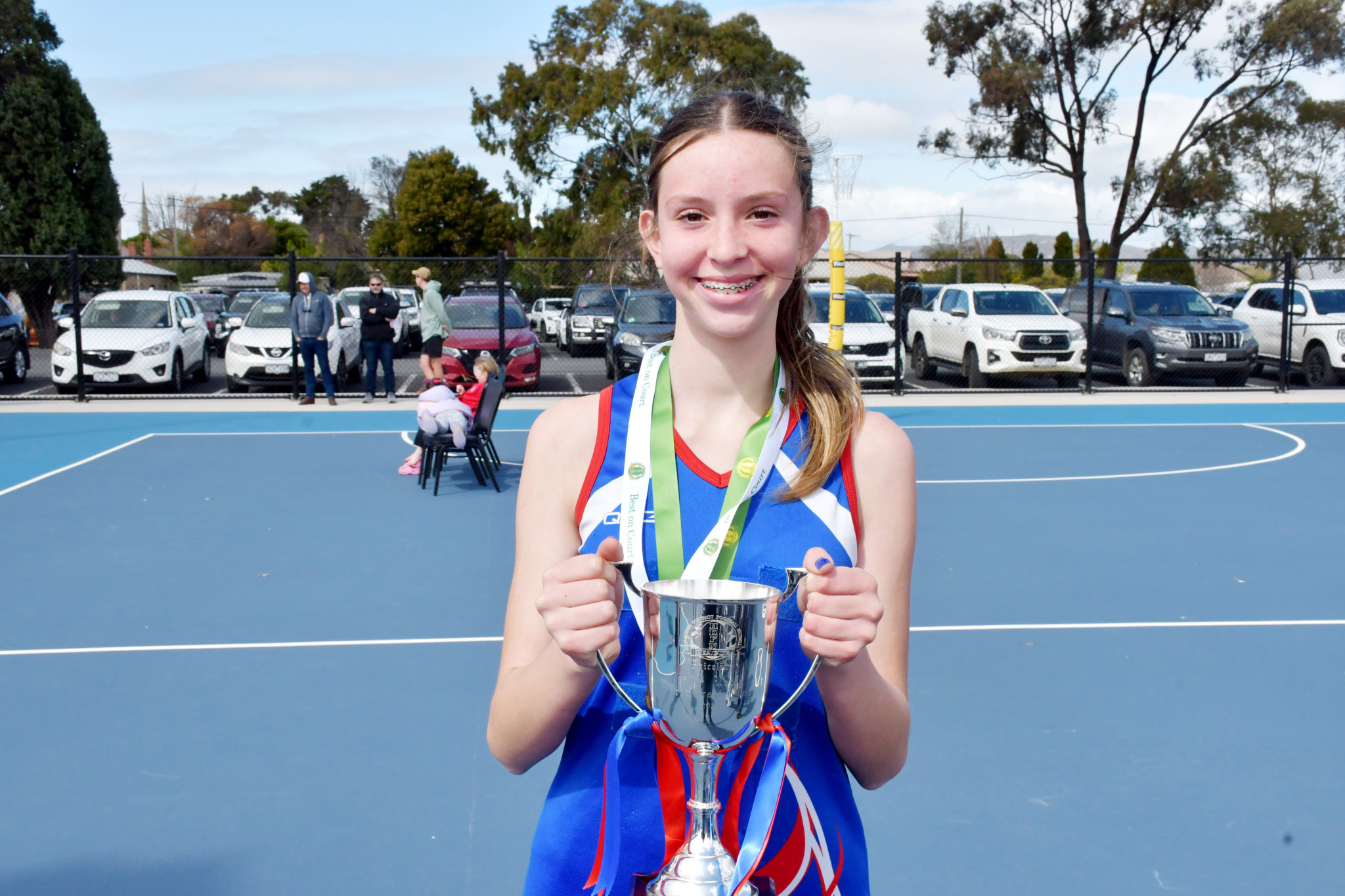 Ilze Van Zyl with the premiership cup and her best-on-the-court medal for Rupanyup after their win over Kalkee in the 15-and-under grand final.