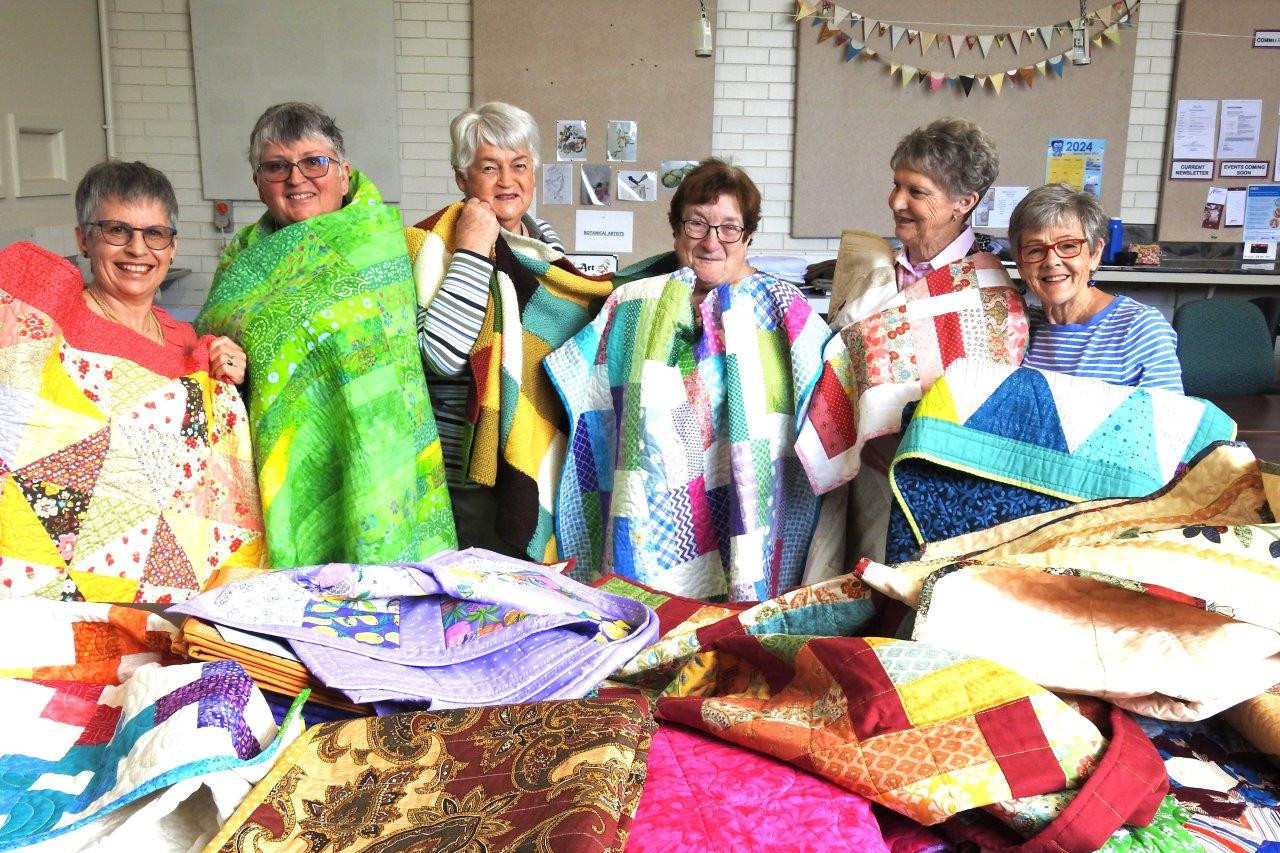 Horsham Patchwork Quilters members Sally Lockwood, Pauline Lentsment, Faye Cameron, Jane Bolwell, Pam Langlands and Lea Crammond show some of the quilts made for palliative-care patients.
