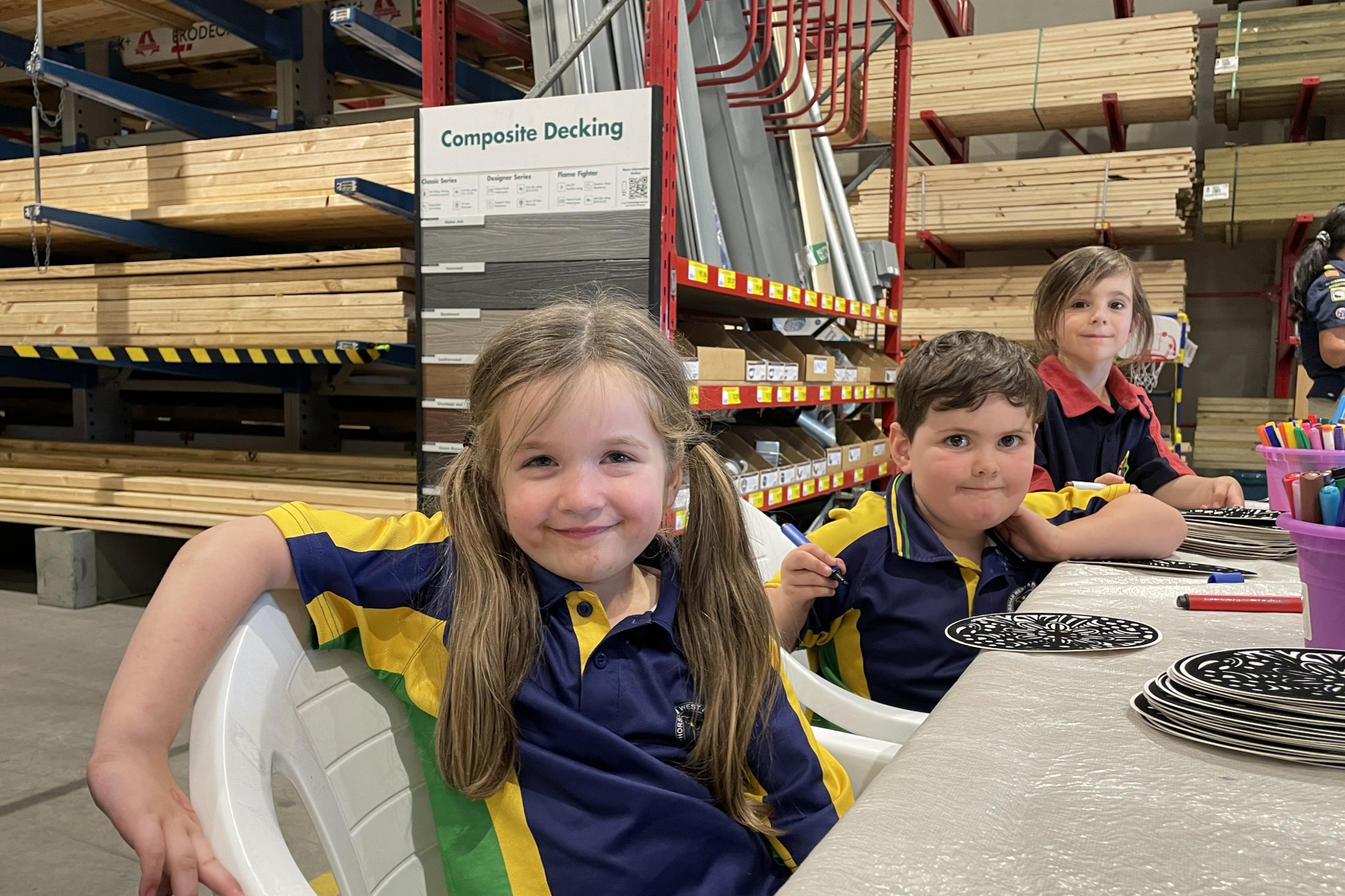 Five-year-olds Alexia, Madeline and Holly enjoy colouring in felt pictures at Bunnings' Easter Family Night.