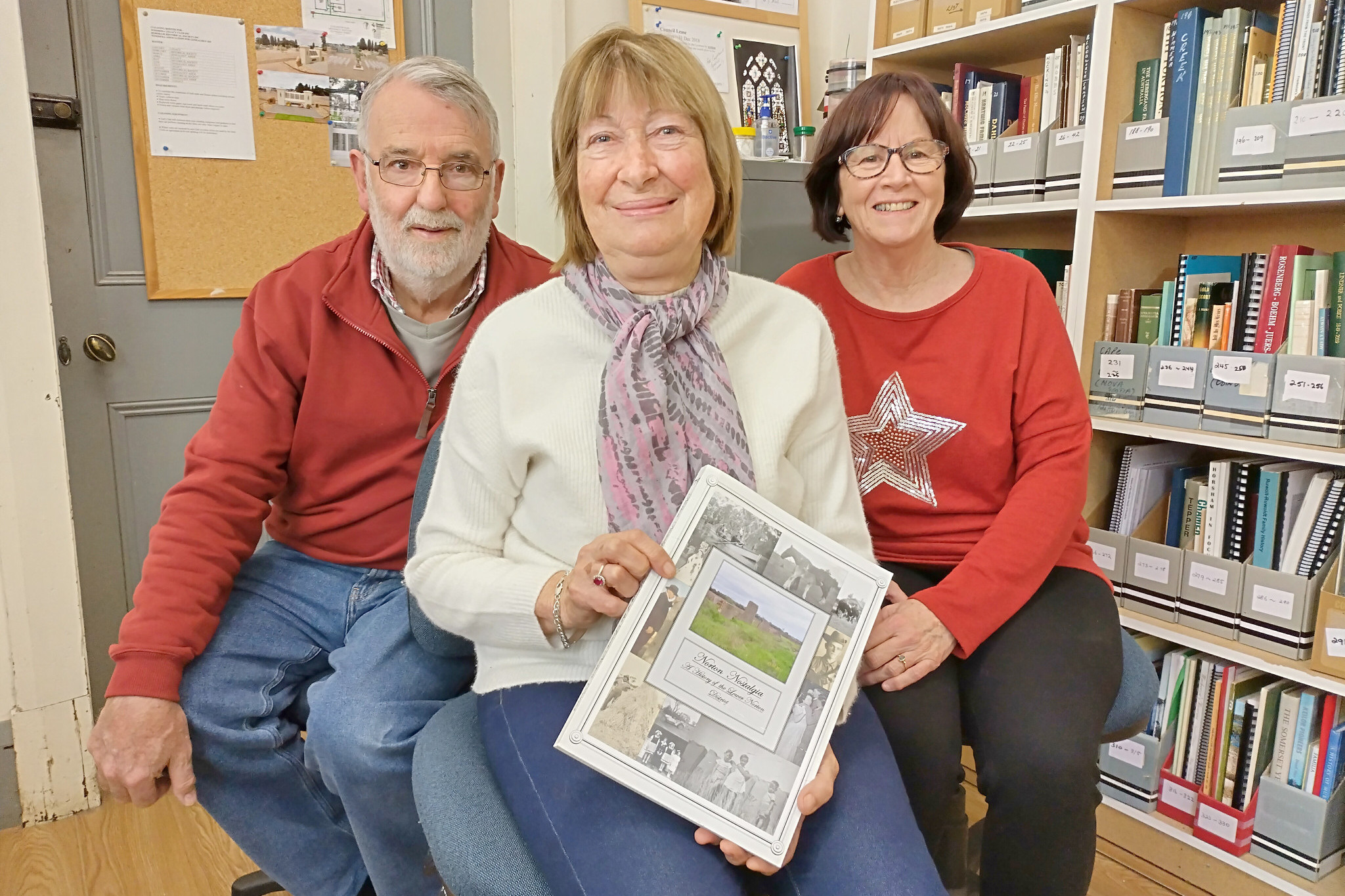 Society research officer and treasurer Ian Rees, author and committee member Wendy Donald and secretary Karen Lyons show some of the items available for research information. Ms Donald wrote the history book - Norton Nostalgia - she holds.