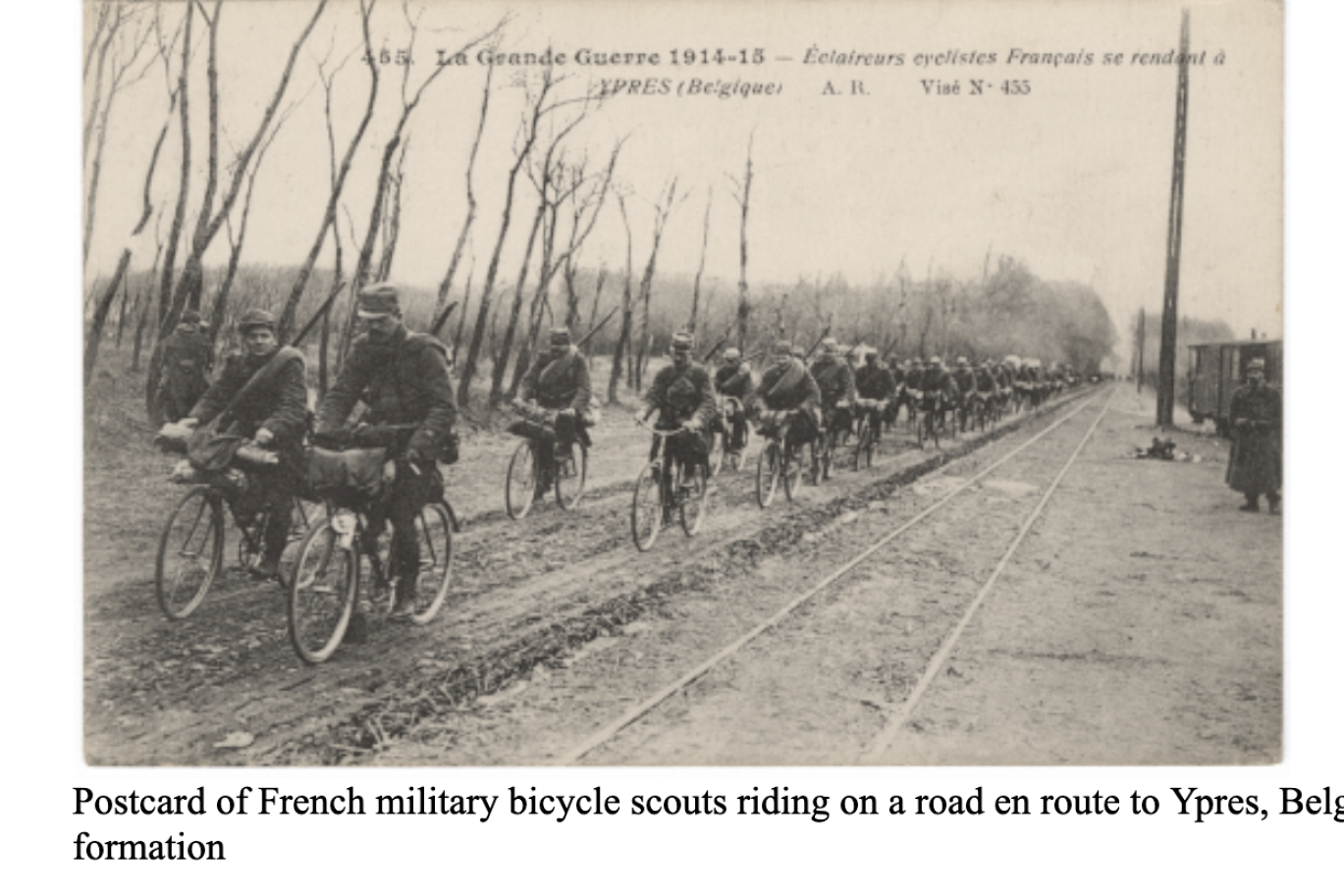 Postcard of French military bicycle scouts riding in formation on a road en route to Ypres, Belgium.