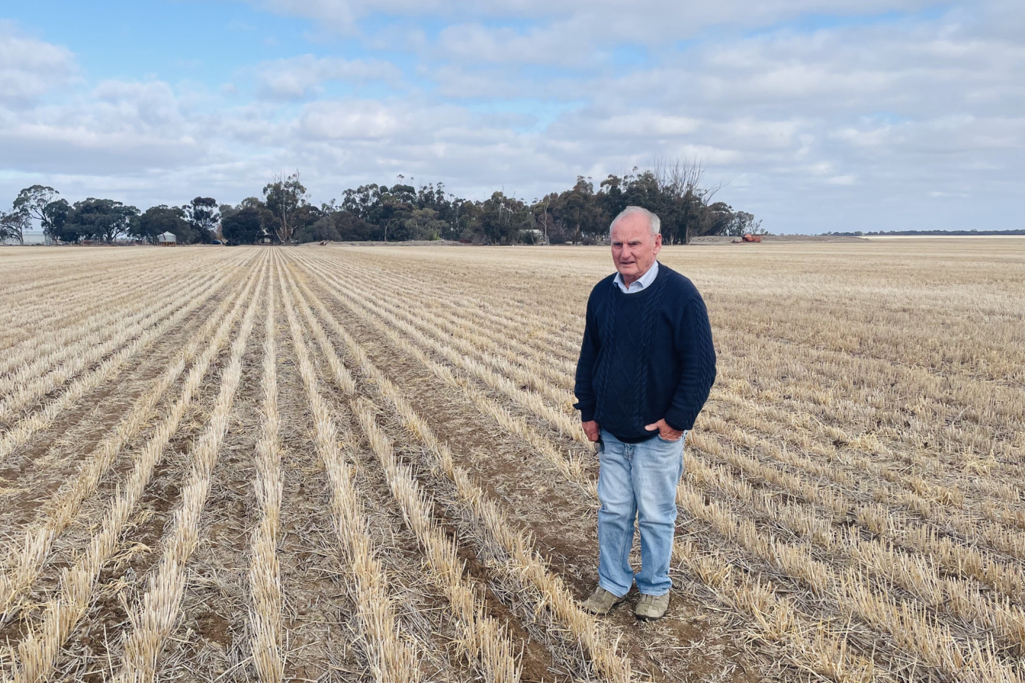 Fourth generation farmer Peter Byrne stands on the land that Astron Minerals Ltd wants to buy. His home surrounded by the trees he and his wife planted in the background. Photo: SHERYL LOWE