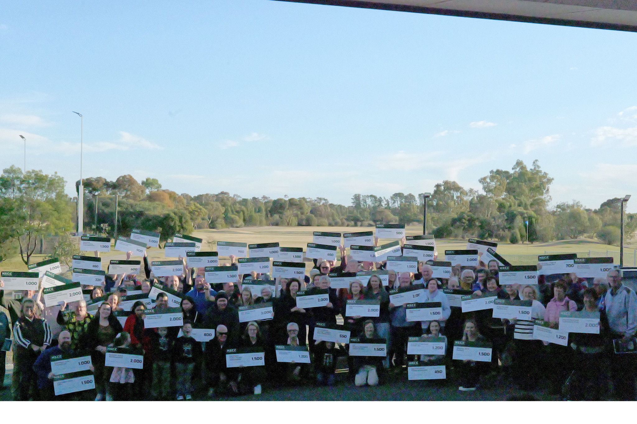 The various sports clubs and community group representatives hold up their funding cheques from the Horsham Sports & Community Club.
