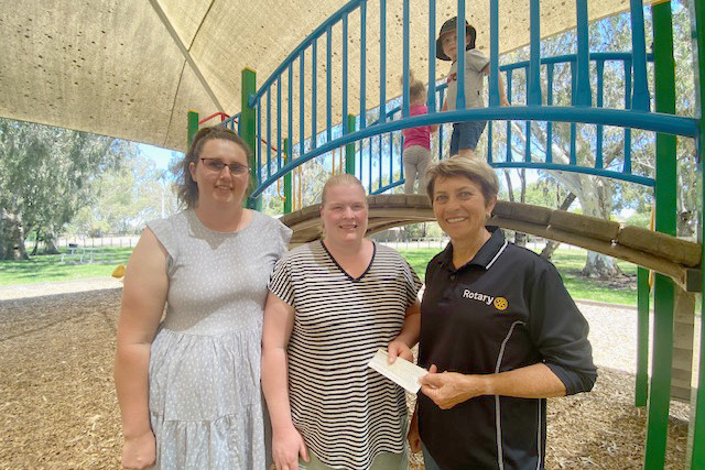 Warracknabeal Rotary Club's Wendy Hewitt presents Warracknabeal Playgroup's Natalie Hewitt and Lucy Holland with a donation.