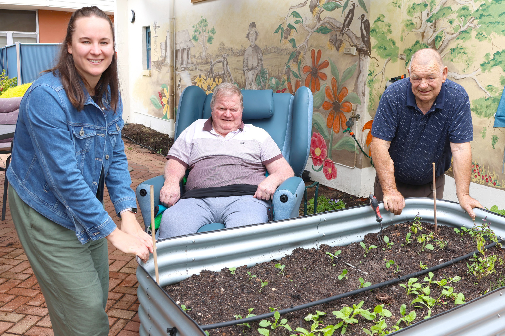 Dimboola Meaningful Life coordinator Megan Naylor with residents Graeme and the late David in a section of the Bretag garden.