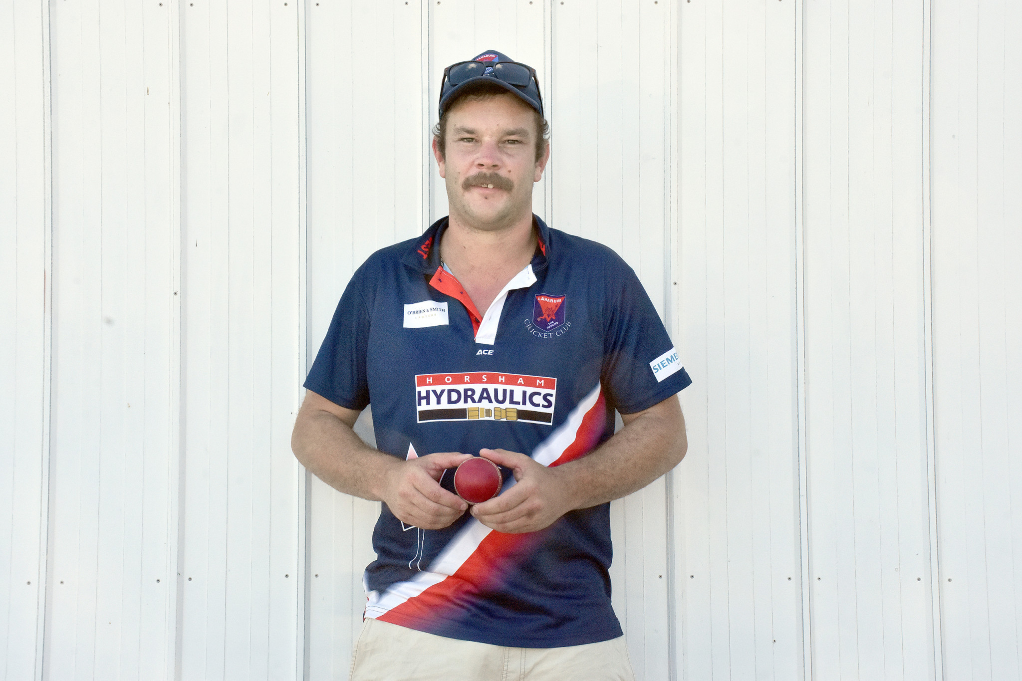 Joel Pymer with the ball he claimed five wickets with.