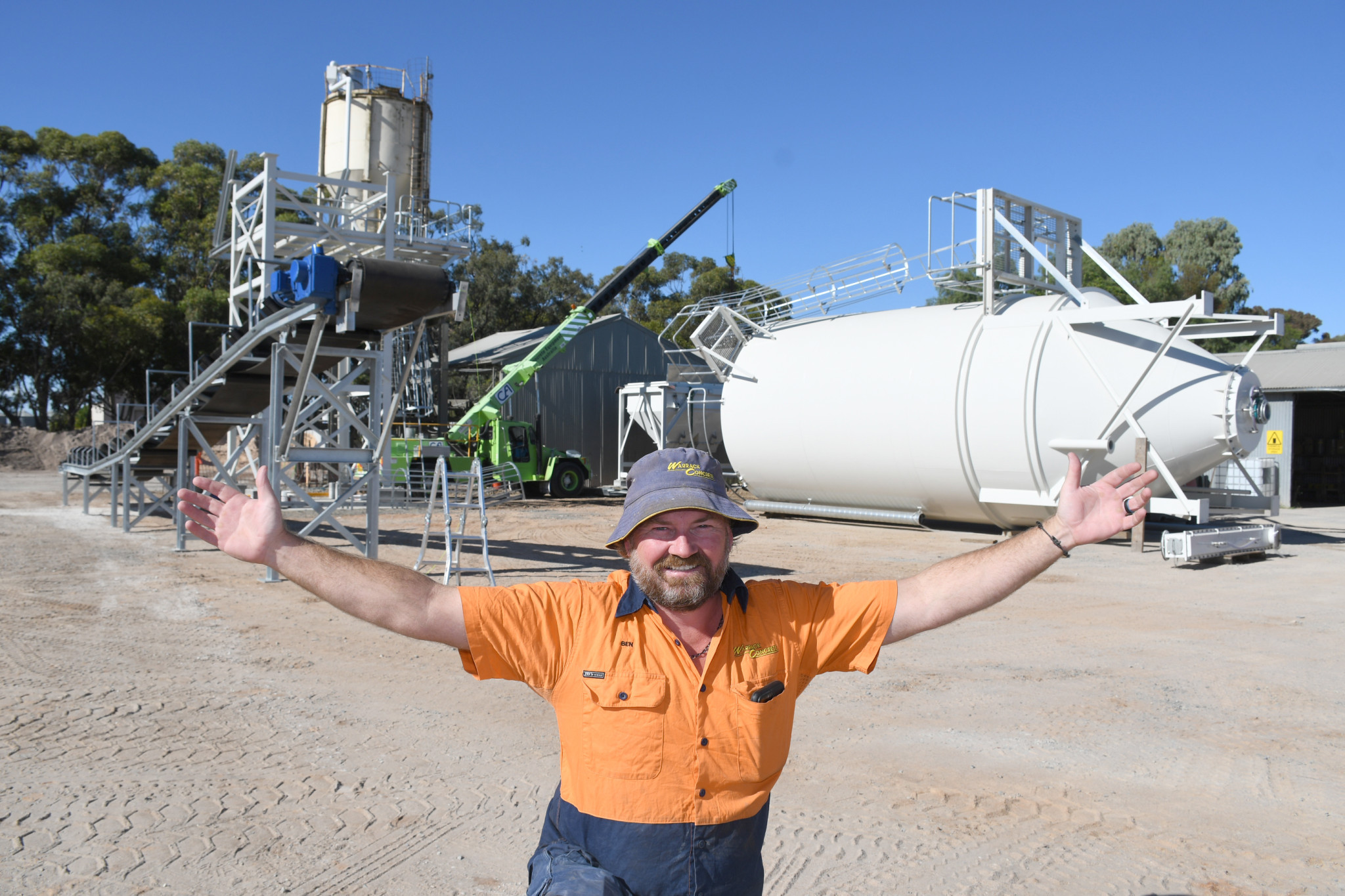 Warrack Concrete manager Ben Jenner is dwarfed by the new 200 tonne bulk cement tower, that was lifted into place by Fred Blake Cranes last week. PHOTO David Ward