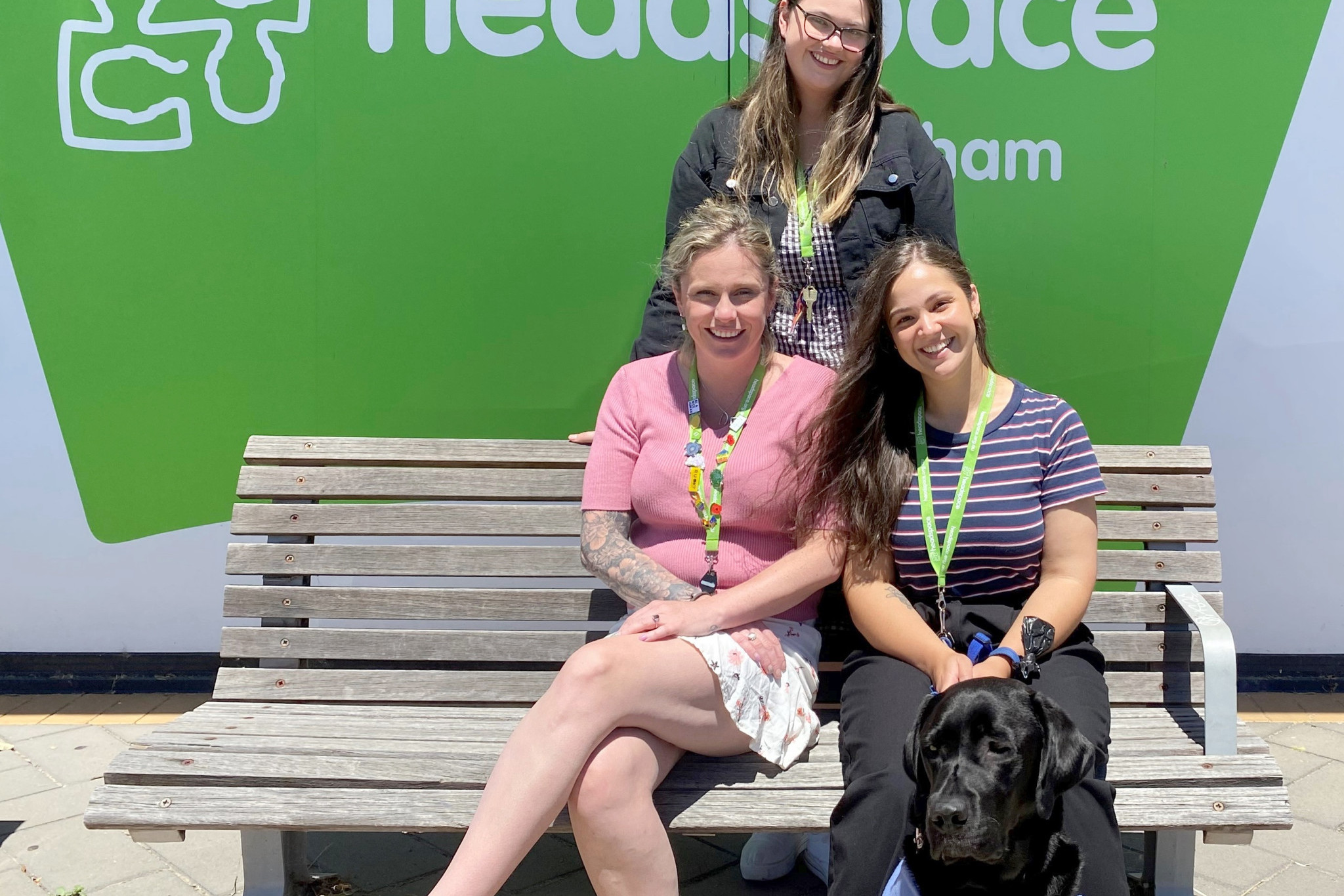 Youth outreach worker Cassandra Jeffrey (back) with client services officer Kate Adams, Alisha McLaughlin and Louie the therapy dog.