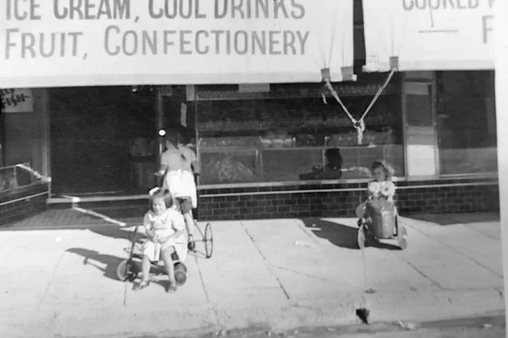&shy;&shy;&shy;&shy;&shy;&shy;&shy;&shy;Marina (born 1938), Elini, known as Helen (born 1933), Noel (born 1944) in the cyclops pedal car in front of the Bon Bon Cafe (circa 1946-47).