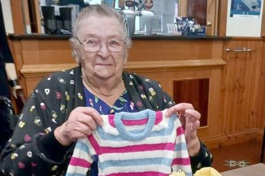 Hazel Ferris with some of the clothes she has knitted for the community's premature babies