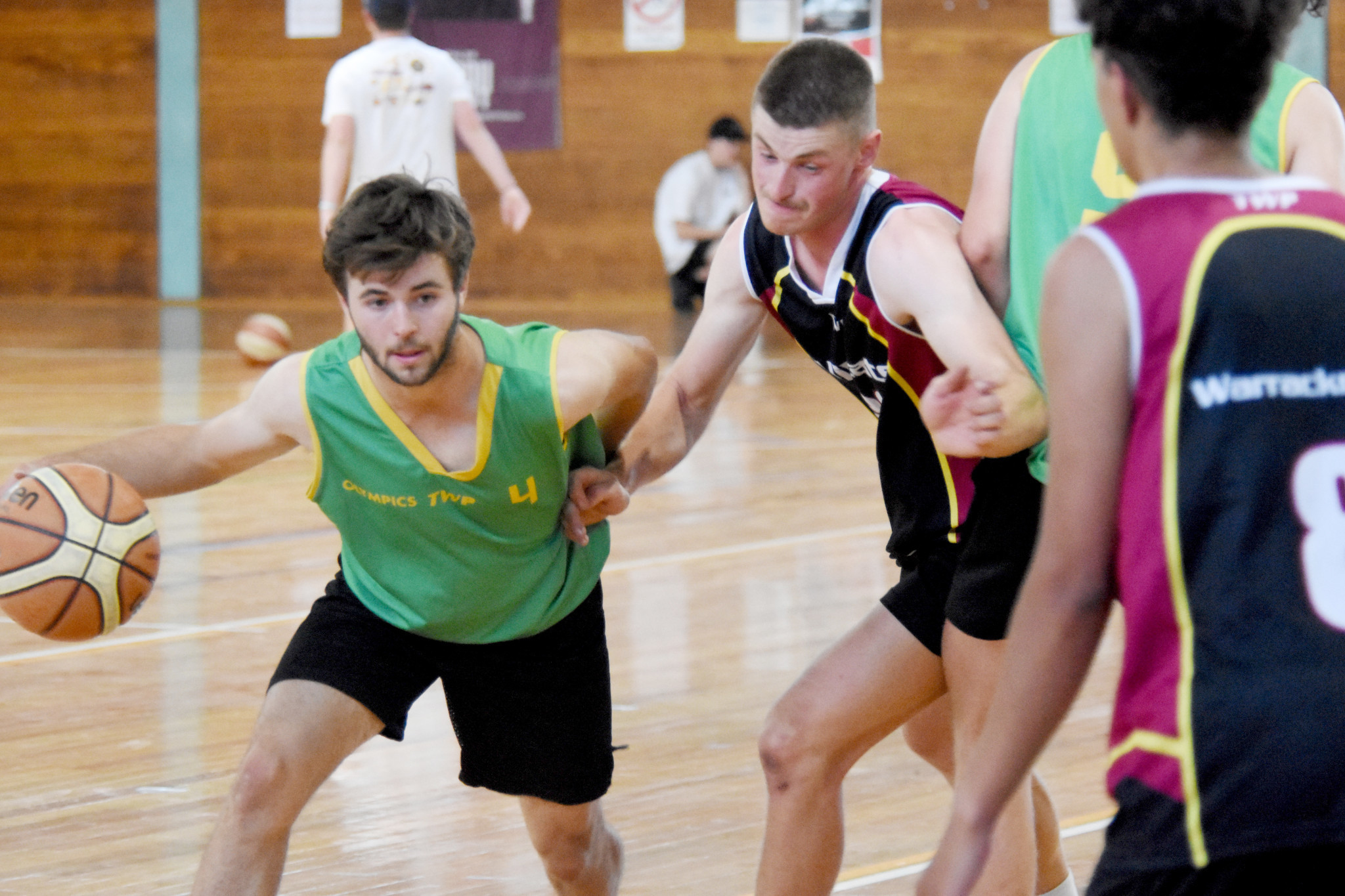 Charlie Penny makes his way through traffic for Olympics against Wildcats.