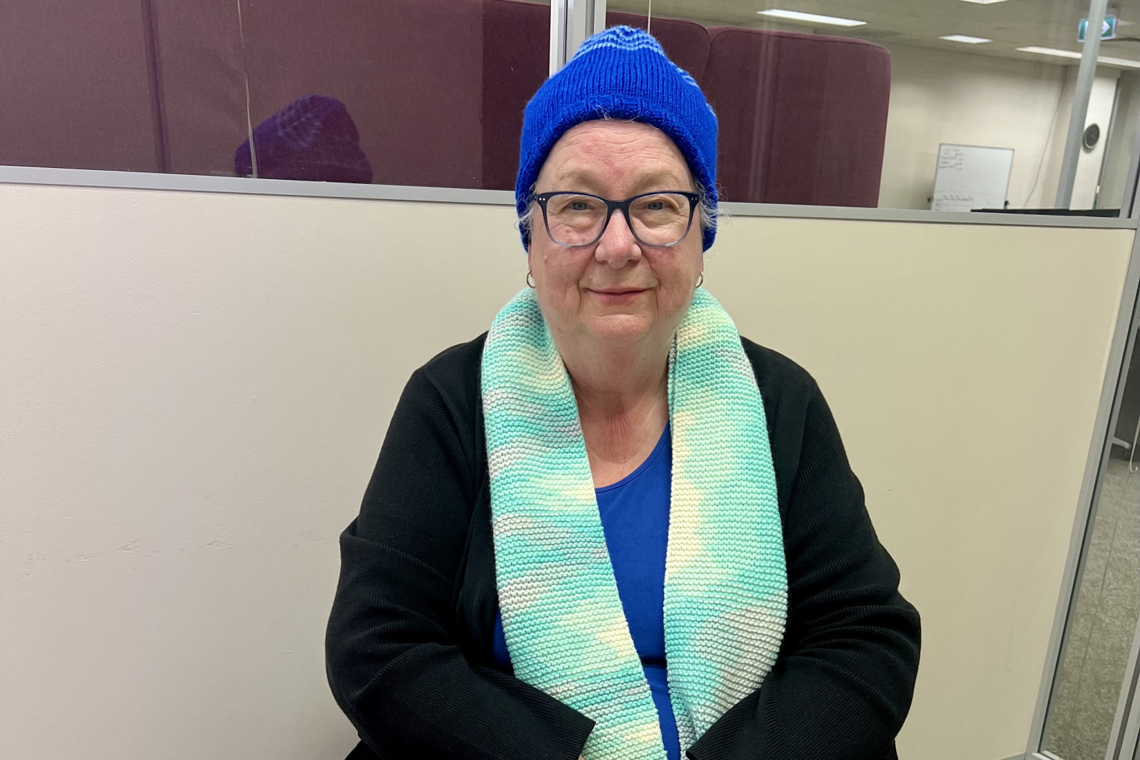 Margery Pannan, 76, proudly displays a selection of her handmade knitted items, part of the hundreds she donates each year to support those in need through the charity group KOGO (Knit One Give One). Photo: TAYYAAB MASROOR