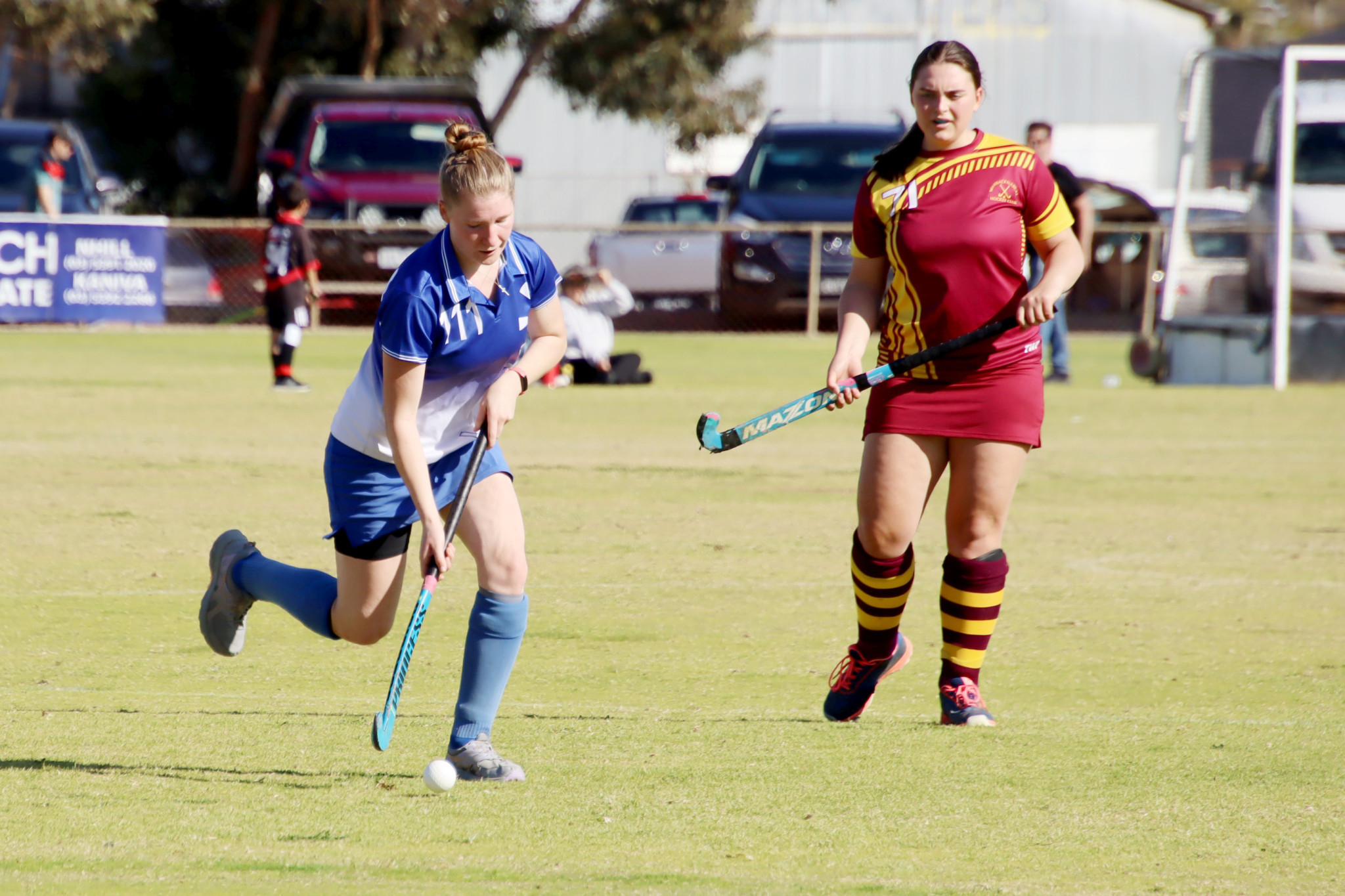 Imogen Williams runs with the ball while Warracknabeal’s Clarice Bennett looks for an opportunity to tackle.