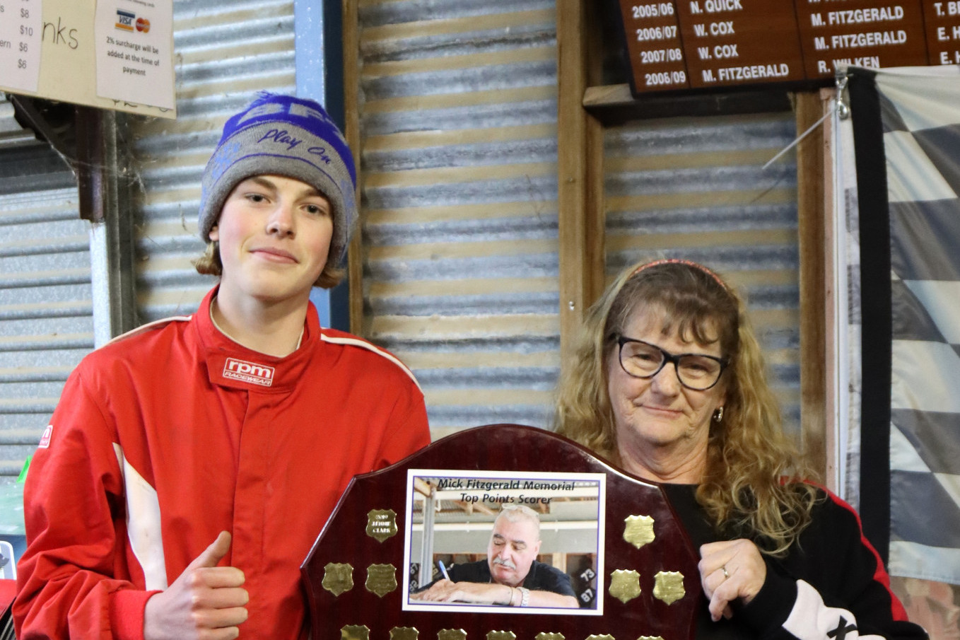 Jack Mills was the top pointscorer and winner of the Mick Fitzgerald Trophy. He raced in the 1200 junior sedan class. He received the trophy from Sue Fitzgerald. PHOTO: TANYA EASTWOOD