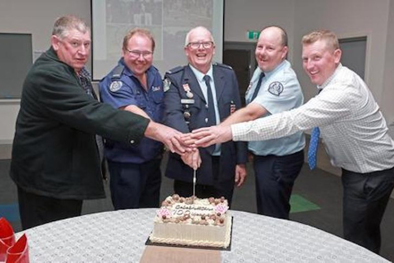 Darren Witmitz, John Heinjus, Brian Charles, Josh McCabe and Brad Witmiz cut the cake celebrating 100 years of the CFA in Kaniva.