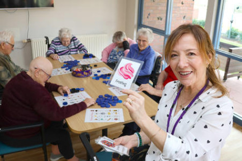 Meaningful Life assistant Marlene Curran entertains residents at Kurrajong Lodge.