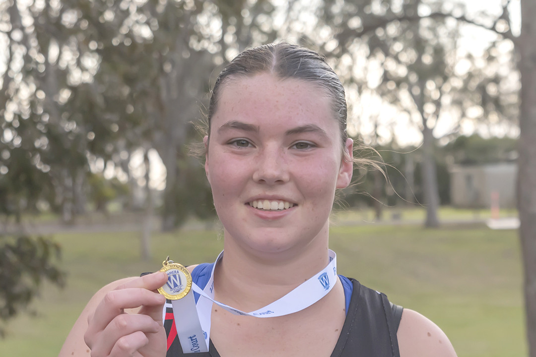 Rori Marshman proudly showing off her medal.