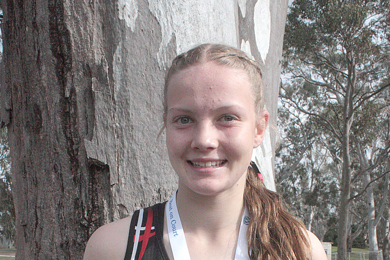 Rising star Ruby Bethune proudly shows off her best on the court medal.