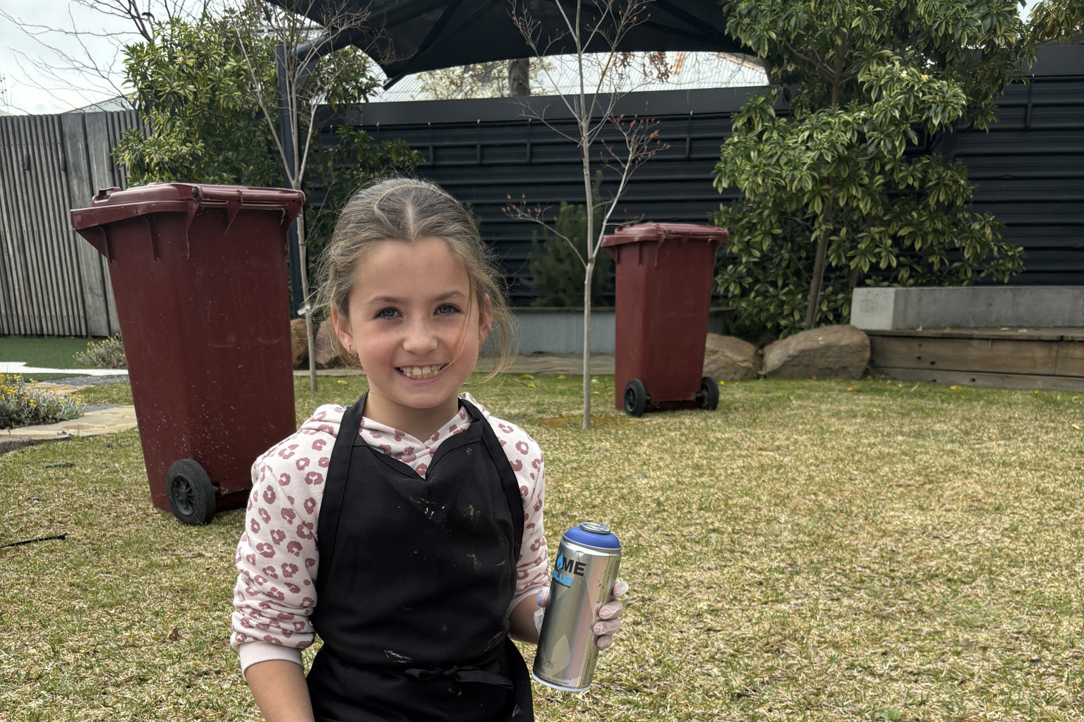 Ruby Seers, 9, uses pink and purple to colour the background of her name. Photo: CAITLIN MENADUE